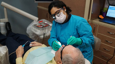 Dental Hygiene student working with a patient