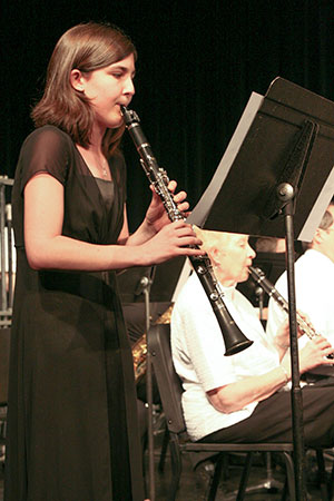 woman playing the clarinet at a concert